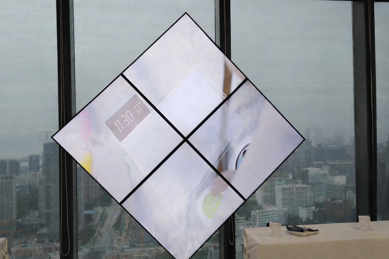 Custom diamond-layout display wall installed beside a city-view window