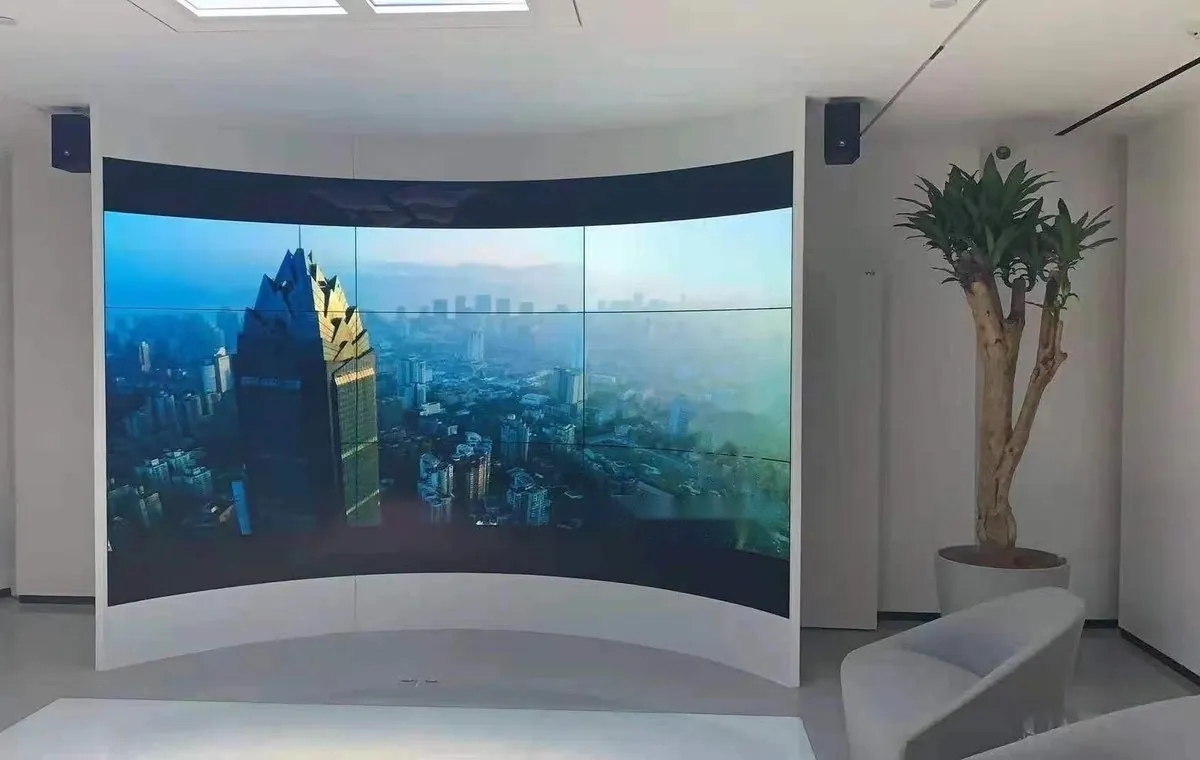 Curved flexible OLED display wall in a reception space