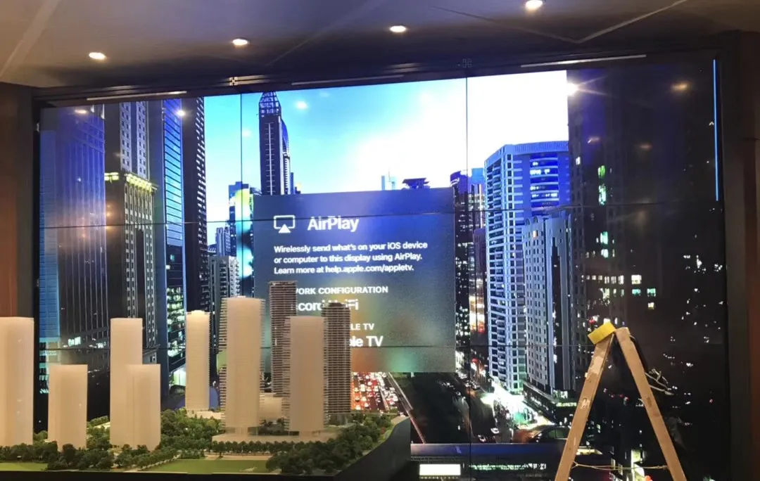 Video wall installed beside a model in a property showroom