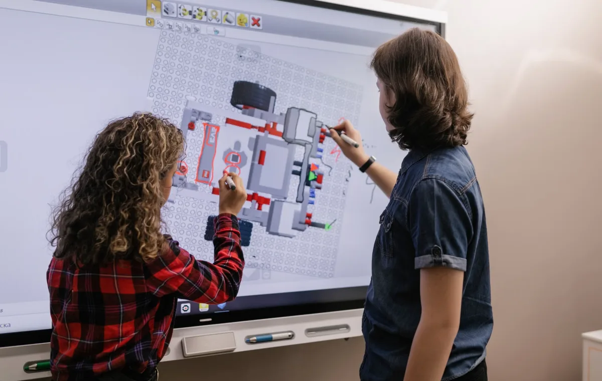 Students using an interactive board in a classroom