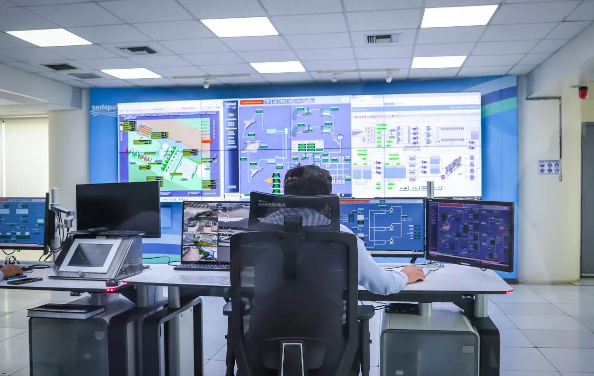 Operator in a control room with an LCD video wall