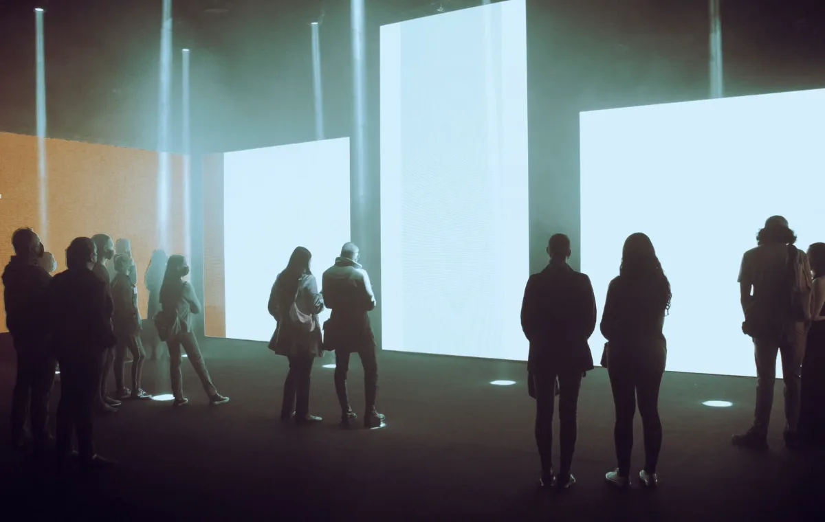Visitors in an immersive projection exhibition space