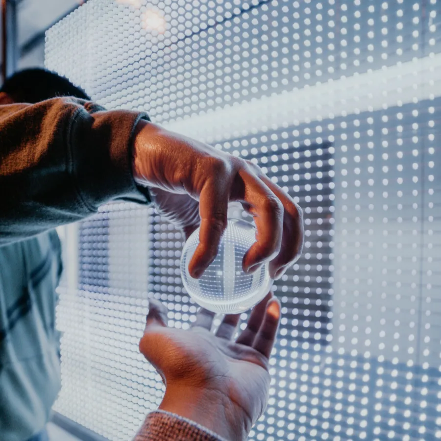 Hand near the surface of an LED wall showing individual pixels