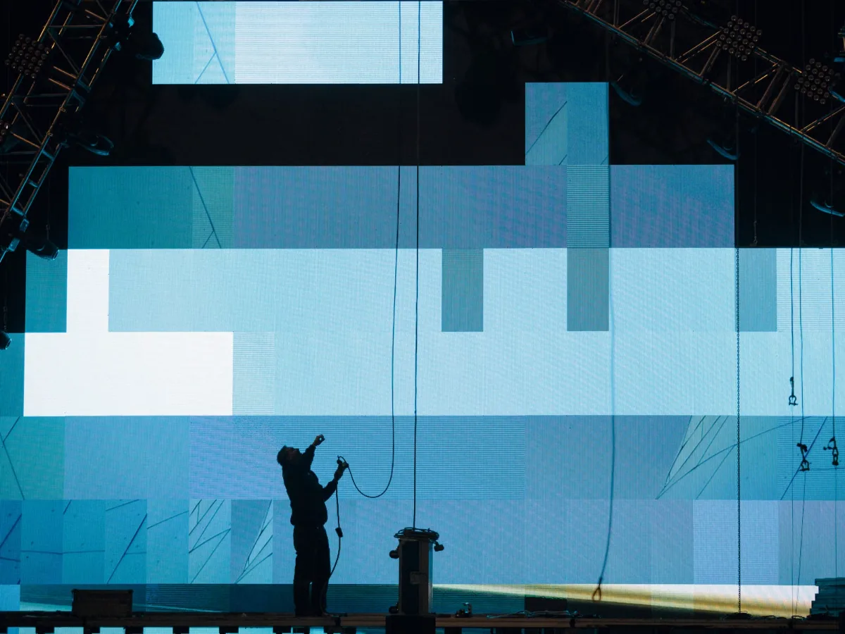 Technician installing an LED wall on a stage